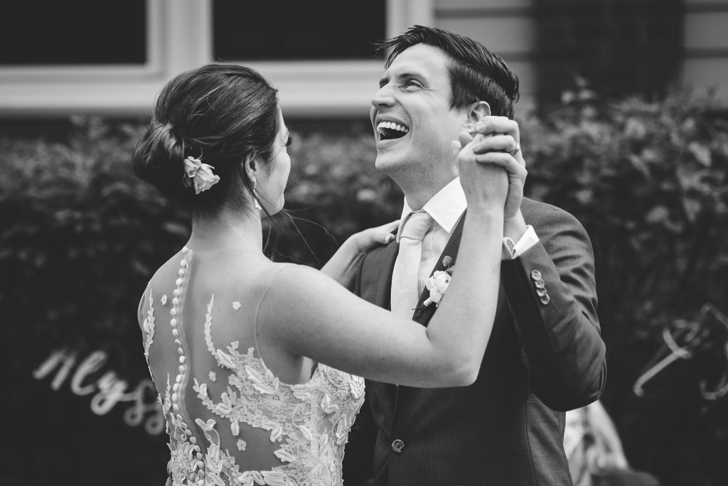 bride and groom share a first dance and laugh during their ravenswood microwedding in chicago with ed + aileen photography