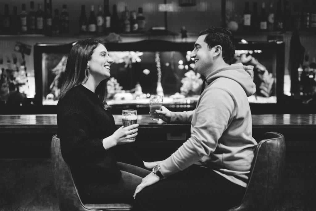 A couple enjoys beers together at their favorite bar in Chicago. 