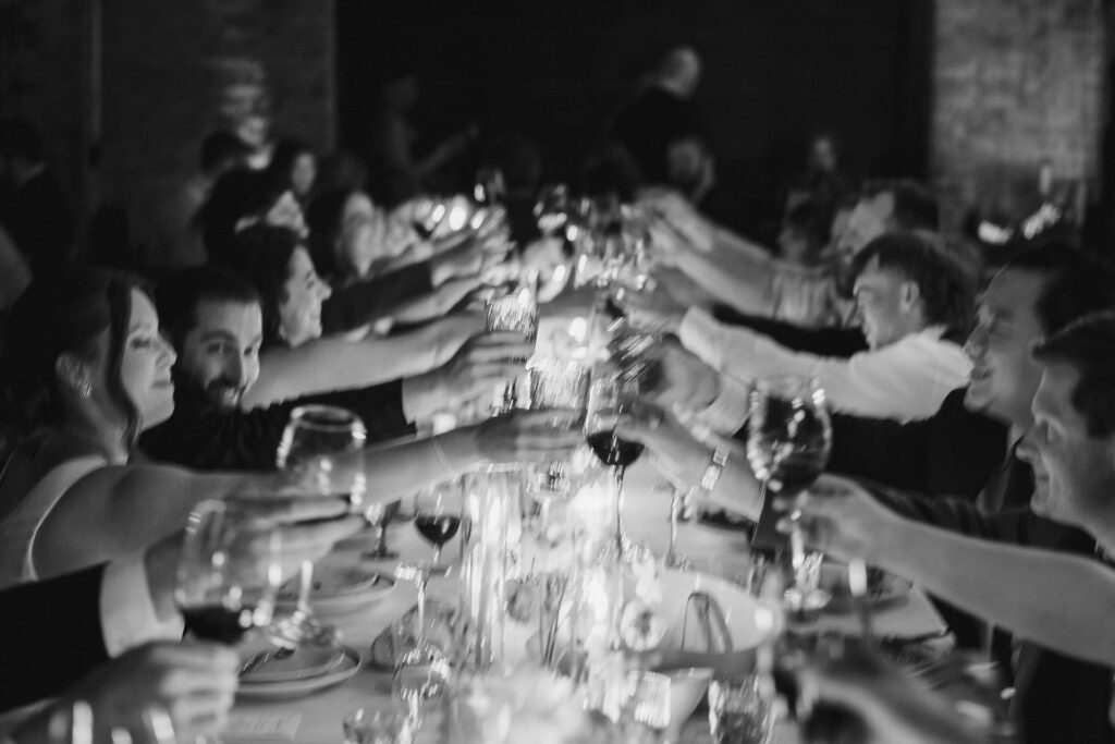 Guests sharing a toast at Chicago wedding reception at Revel Motor Row